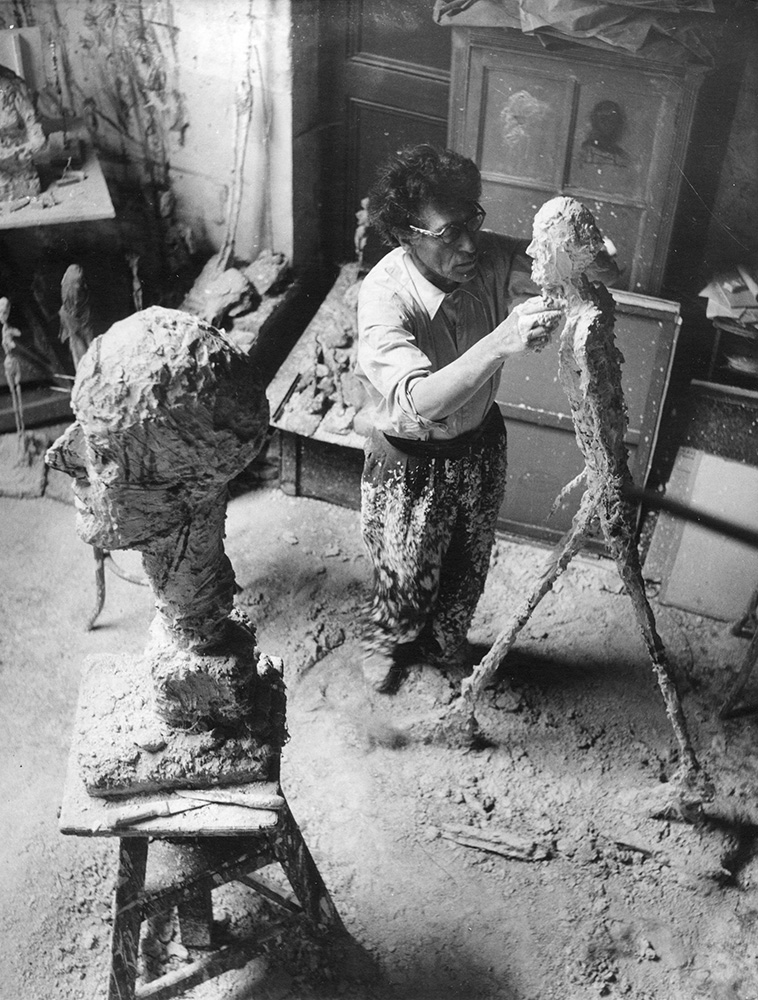 Giacometti working in his Paris studio, 1958, from