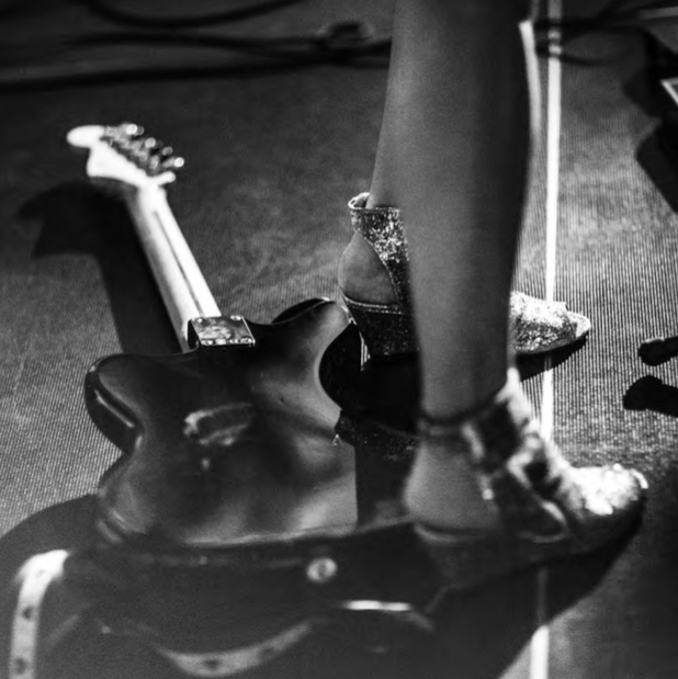 Photograph of Kim Gordon playing with Bill Nace in their experimental electric guitar duo Body/Head, live at the Benaki Museum in Athens, Greece, on June 12, 2015, is reproduced from 