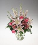 A clear vase arrangement of pink and white flowers 