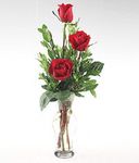 A glass vase of three Red roses w/ sm teddy bear