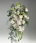 Arrangement of mixed white flowers on an easel.
