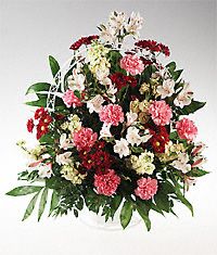 Mixed flower in a handled basket sympathy