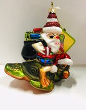 Santa riding turtle Sc Christmas glass ornament