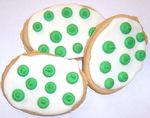 White Iced Egg Shaped Sugar Cookies with Green Polka-Dots in a Mini Tin