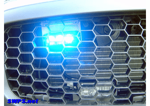 Whelen TIR-3 installed behind grille of Ford Police Interceptor