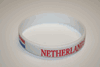 1 NETHERLANDS COUNTRY FLAG SOCCER BRACELET WITH RED AND BLUE WORDING .. FIFA WORLD CUP ...NEW