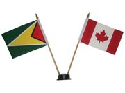 CANADA & GUYANA SMALL 4" X 6" INCHES MINI DOUBLE COUNTRY STICK FLAG BANNER WITH BLACK STAND ON A 10" INCH PLASTIC POLE .. NEW