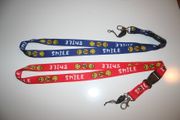 ***SOLD OUT ***2 HAPPY SMILEY FACE LANYARDS KEYCHAINS PASSHOLDERS  .. CHOOSE BETWEEN RED OR BLUE ... NEW