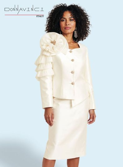 Donna Vinci Couture <br> (Spring/Summer 2026) <br> DV12258-IV <br> <br> IVORY <br> 8 10 12 14 16 18 20 22<br> <br> 2pc. Jacket & Skirt Set <br> Virtual Silk Look Fabric Trimmed With Ruffled/Pleated Novelty Organza Fabric, Trimmed With Gold Buttons & Broach