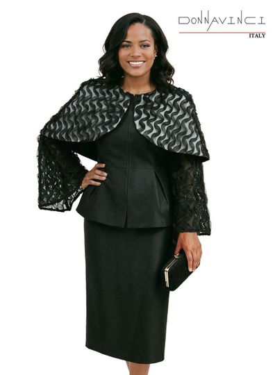 Donna Vinci Couture <br> (Spring/Summer 2026) <br> DV12265 <br> <br> BLACK <br> 8 10 12 14 16 18 20<br> <br> 2pc. Jacket & Skirt Set <br> Virtual Silk Look Fabric, Mini Cape & Sleeves Trimmed With Novelty Ruffled Fabric