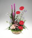 A vegetative garden basket arrangement of flowers
