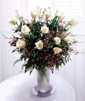 Dozen rose bouquet in a glass vase
