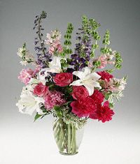 Mixed garden flowers in a clear vase.