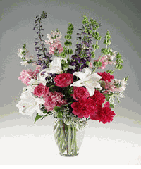 Mixed garden flowers in a clear vase.