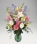 Pastel color flowers arranged in a vase.