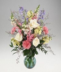 Pastel color flowers arranged in a vase.