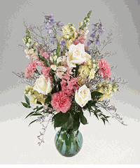 Pastel color flowers arranged in a vase.