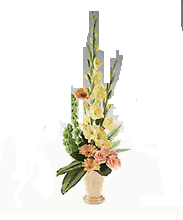 Pottery vase of yellow and peach flowers.