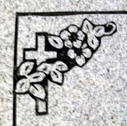 Cemetery Headstone Cross with flowers combination border design on gray granite