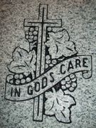 Engraved In God's Care Cross and Grapevine Cemetery Headstone Design 607 on Gray Granite