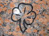 Three Leaf Clover Engraved onto Marble Red Granite Three Leaf Clover Engraved onto Marble Red Granite