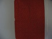 N122,"Tiny White Flowers Against A Red Background"