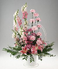 A basket arrangement of pink and lavender flowers.