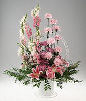 A basket arrangement of pink and lavender flowers.