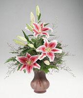 A vase of Stargazer lilies.