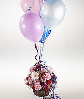 An arrangement of flowers and balloons.