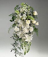 Arrangement of mixed white flowers on an easel.