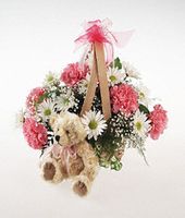 Basket arrangement with plush bear for a baby girl.