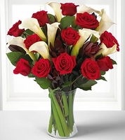 Classic red roses blend with the elegance of white calla lilies 