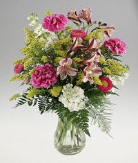 Clear vase arrangement of assorted flower