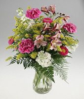 Clear vase arrangement of assorted flower