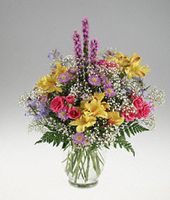 Clear vase of colorful mixed flowers