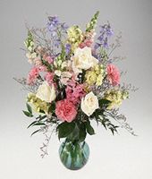 Pastel color flowers arranged in a vase.
