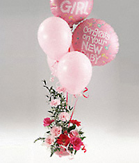 Pink flowers arrangement with a balloon bouquet.