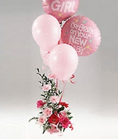 Pink flowers arrangement with a balloon bouquet.