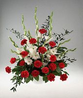 Vase arrangement of red and white flowers.